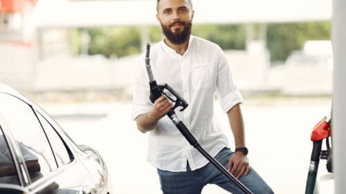 Wszystkie wiadomości - handsome man pours gasoline into tank car