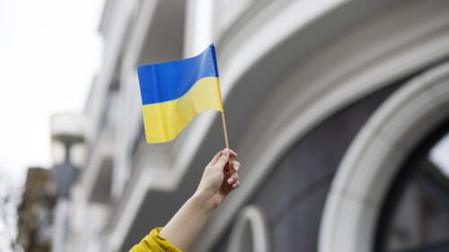 Wszystkie wiadomości - person holding ukrainian flag