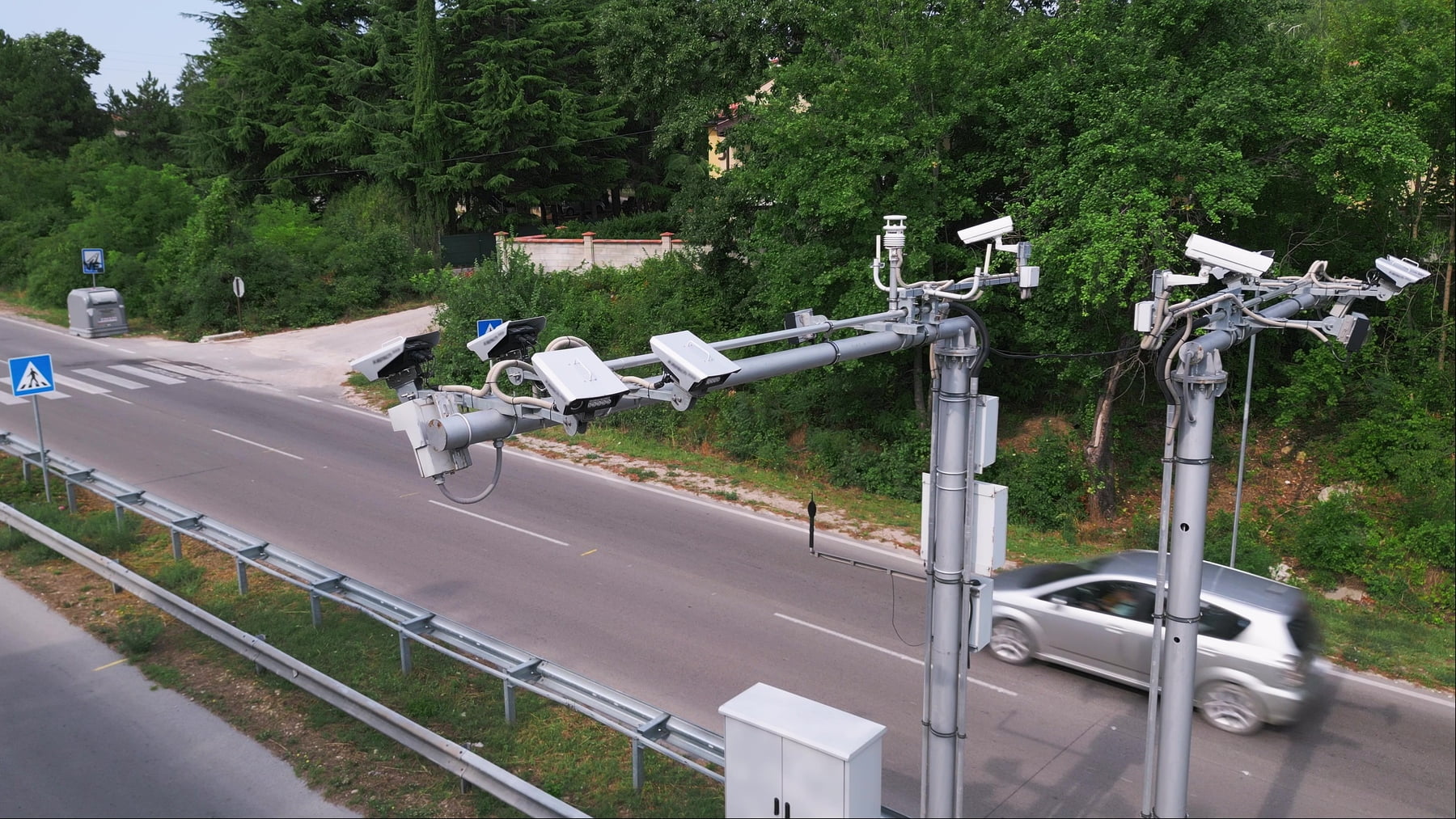 Cameras and speed control radars along a busy highway monitor and record speeding violations. Drone view